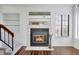 Living Room with tiled fireplace, wood floors, and shelving is perfect for relaxation and reading at 4802 E Kentucky Ave # E, Denver, CO 80246