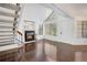 Open floor plan living room featuring a fireplace, hardwood floors, and abundant natural light at 4802 E Kentucky Ave # E, Denver, CO 80246