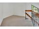 Bright loft area featuring neutral carpeting and natural lighting at 4802 E Kentucky Ave # E, Denver, CO 80246