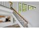 Modern staircase with natural light and a view into the updated kitchen at 4802 E Kentucky Ave # E, Denver, CO 80246