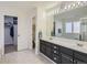 Bathroom features double vanity, large mirror, and a soaking tub at 10141 Brady Pl, Highlands Ranch, CO 80130