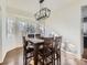 Dining room with hardwood floors, large windows, and a wooden table with chairs at 10141 Brady Pl, Highlands Ranch, CO 80130