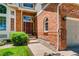 Brick facade with a burgundy door and a walkway leading to the entrance at 10141 Brady Pl, Highlands Ranch, CO 80130