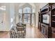 Living room with hardwood floors, bay window, and built-in entertainment center at 10141 Brady Pl, Highlands Ranch, CO 80130