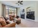 Living room with fireplace and large windows at 10141 Brady Pl, Highlands Ranch, CO 80130