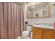 Tidy bathroom with a shower and decorative mirror above sink at 3300 W Florida Ave # 51, Denver, CO 80219