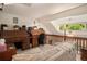 Upstairs loft space with vintage desk, wood railing and natural light at 3300 W Florida Ave # 51, Denver, CO 80219