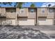 View of exterior featuring multiple garage doors, light colored siding, and well maintained landscaping at 3300 W Florida Ave # 51, Denver, CO 80219