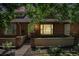Charming brick townhome featuring a bay window, neat landscaping, and a welcoming front entrance at 3300 W Florida Ave # 51, Denver, CO 80219