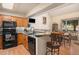 Open kitchen and dining area features oak cabinets, breakfast bar, and ample counter space at 3300 W Florida Ave # 51, Denver, CO 80219