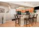 Well-equipped kitchen with oak cabinets, a breakfast bar, and modern appliances at 3300 W Florida Ave # 51, Denver, CO 80219