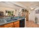 Open kitchen and dining area features oak cabinets and a breakfast bar at 3300 W Florida Ave # 51, Denver, CO 80219