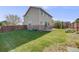 Extensive backyard featuring green grass, wood fence, and a concrete patio at 19294 E Warren Pl, Aurora, CO 80013