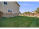 Expansive backyard with a lush green lawn and a wooden privacy fence at 19294 E Warren Pl, Aurora, CO 80013