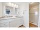 Bright bathroom has a double sink vanity with tile backsplash and a glass-enclosed shower at 19294 E Warren Pl, Aurora, CO 80013
