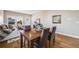 Cozy dining area with hardwood floors, a wooden table, and views into the living room at 19294 E Warren Pl, Aurora, CO 80013