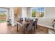 Inviting dining area featuring hardwood floors, a wooden table with seating for four, and natural light at 19294 E Warren Pl, Aurora, CO 80013