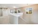 Bright hallway with a view of the home office and a window with natural light at 19294 E Warren Pl, Aurora, CO 80013