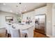 Bright kitchen boasts white cabinets, stainless steel appliances, granite counters, and a central island at 19294 E Warren Pl, Aurora, CO 80013