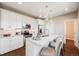 Modern kitchen featuring white cabinets, stainless steel appliances, and an island with bar seating at 19294 E Warren Pl, Aurora, CO 80013