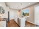 Bright kitchen with white cabinets, stainless steel appliances, and a functional island with seating at 19294 E Warren Pl, Aurora, CO 80013