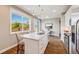 Spacious kitchen featuring stainless steel appliances, granite countertops, and a large window at 19294 E Warren Pl, Aurora, CO 80013