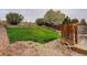 Backyard with rock bed and grassy tiered slope and wooden fence at 20626 Willowbend Ln, Parker, CO 80138