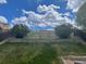 Tiered backyard with grassy slope and wood retaining walls and fence at 20626 Willowbend Ln, Parker, CO 80138