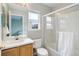 Bathroom featuring a glass enclosed shower, wood cabinets, and window at 20626 Willowbend Ln, Parker, CO 80138