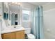 Bathroom featuring a tub and shower, wood cabinets, and window at 20626 Willowbend Ln, Parker, CO 80138