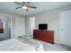 Spacious bedroom featuring a ceiling fan, plush carpet, and a large dresser at 20626 Willowbend Ln, Parker, CO 80138