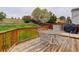 Deck with metal table and chairs overlooking grassy tiered backyard at 20626 Willowbend Ln, Parker, CO 80138
