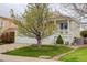 Inviting yellow two-story house with a cozy porch, mature landscaping, and ample curb appeal at 20626 Willowbend Ln, Parker, CO 80138