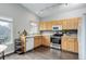 Bright kitchen with stainless steel appliances, wooden cabinets, and tile countertops at 20626 Willowbend Ln, Parker, CO 80138