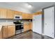 Kitchen features light wood cabinets, black appliances, tile backsplash, and wood flooring at 20626 Willowbend Ln, Parker, CO 80138