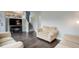 Living area with hardwood floors, TV and stairs leading to upper level at 20626 Willowbend Ln, Parker, CO 80138