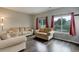 Cozy living room with hardwood floors and large windows with backyard views at 20626 Willowbend Ln, Parker, CO 80138
