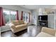 Bright living area featuring hardwood floors, large windows and an entertainment center at 20626 Willowbend Ln, Parker, CO 80138