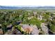 Aerial view of a condo complex nestled among mature trees, showcasing the community and mountain views at 6110 Habitat Dr # 2, Boulder, CO 80301