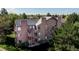 Aerial view of apartment building with wooden balconies, and stairs surrounded by mature trees and landscaping at 6110 Habitat Dr # 2, Boulder, CO 80301