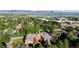 Aerial shot of condos with mountain views, surrounded by green trees and nearby commercial buildings at 6110 Habitat Dr # 2, Boulder, CO 80301