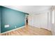 This bedroom has wood flooring, closet space, teal walls, and bright natural light, providing comfort at 6110 Habitat Dr # 2, Boulder, CO 80301