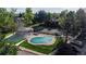 Community pool area with a gazebo, hot tub, tennis court, and well-manicured lawns at 6110 Habitat Dr # 2, Boulder, CO 80301