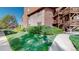 Exterior angle view of apartment complex featuring stone and timber accents surrounded by lush green grass and landscaping at 6110 Habitat Dr # 2, Boulder, CO 80301