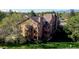 Attractive three-story condo building with wooden balconies surrounded by lush greenery at 6110 Habitat Dr # 2, Boulder, CO 80301
