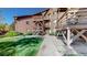 Apartment complex exterior featuring wooden staircases, landscaping, and green lawn creating a relaxing environment at 6110 Habitat Dr # 2, Boulder, CO 80301