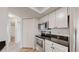 Kitchen featuring white cabinets, granite countertops, and stainless steel appliances at 6110 Habitat Dr # 2, Boulder, CO 80301
