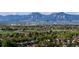 A scenic view with rolling hills and mountains, trees, and houses in the distance at 6110 Habitat Dr # 2, Boulder, CO 80301