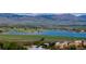 A scenic view of mountains and a blue lake with green grassy fields at 6110 Habitat Dr # 2, Boulder, CO 80301