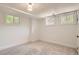 Bright basement featuring carpet floors, white-painted walls, and two windows with natural light at 785 Fillmore St, Denver, CO 80206